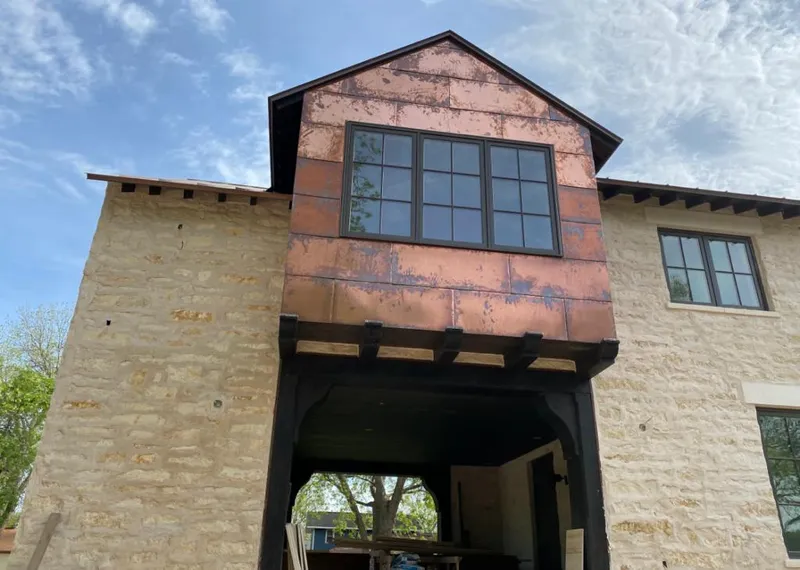 Copper metal panel facade on a stone building for Skylight Installation in Van Wert
